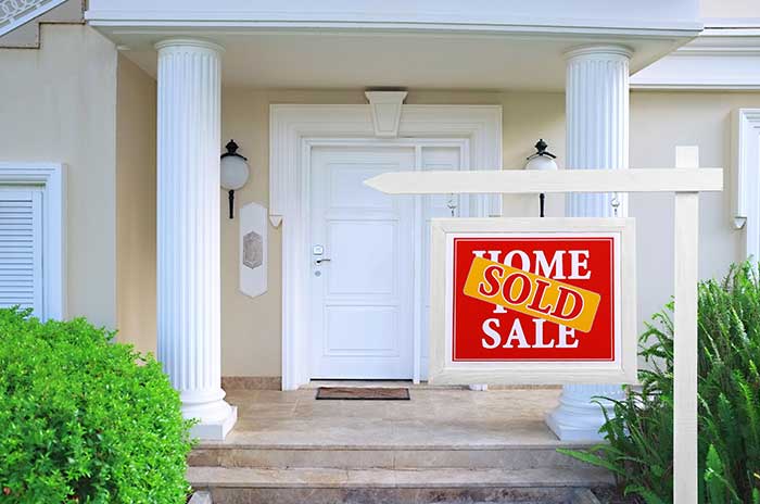 new home with a sold sign